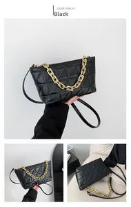 Detailed close-up of a black quilted crossbody bag with gold chain and leather strap