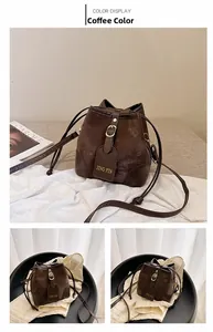Detail view of dark coffee bucket bag with matte finish and metallic JING PIN brand plate