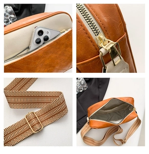 Detail view of ginger leather crossbody bag showing inner pockets and woven strap