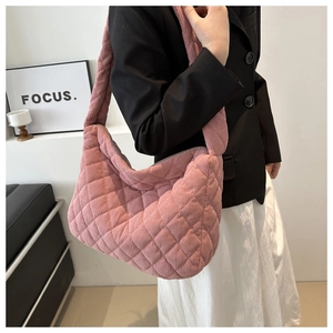 Detail of pink corduroy quilted tote bag showing diamond stitching and soft texture