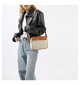 Detail of color-block crossbody bag featuring wavy quilting and a geometric woven strap