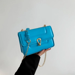 Sac bandoulière minimaliste en cuir bleu lac avec chaîne dorée et fermoir chic en métal