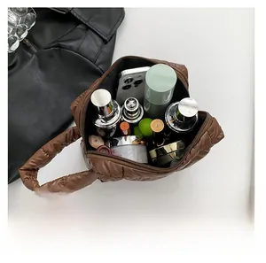 Macro view showing large storage capacity of the brown quilted leather tote bag