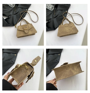 Detail shots of vintage brown faux leather handbag with textured snake pattern metal buckle