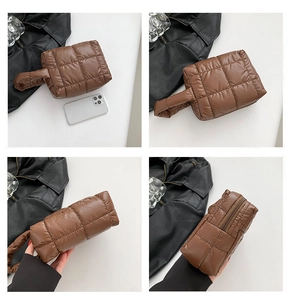 Detail view of brown quilted puffer tote bag with square pattern and top zipper