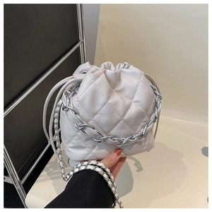 Detail of white quilted bucket bag with silver chain and FASHION & BAGS text