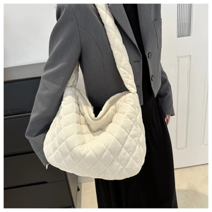 Detailed view of white quilted corduroy tote bag showing soft texture and large capacity