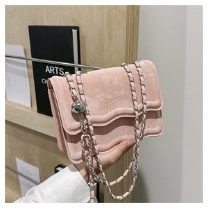 Detail of pink velvet chain bag showing double-layered wave edge and silver metal ball