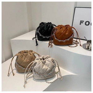 Detailed display of four quilted bucket bags in black, brown, khaki, and cream colors