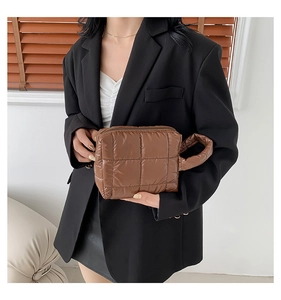 Detailed close-up of dark brown quilted tote bag with soft padded check pattern