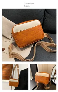 Detail of a brown and cream patchwork PU leather crossbody bag with jacquard strap