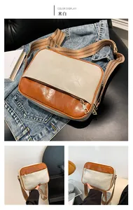 Detail view of cream and brown crossbody bag with V-shaped quilting and vintage strap