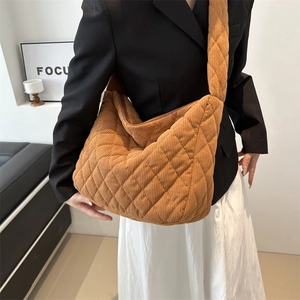 Brown quilted corduroy large tote bag with diamond stitching and wide shoulder strap