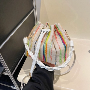 Chic beige bucket bag with rainbow vertical stripes and woven handles in a stylish design