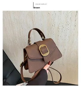 Detailed view of brown retro handbag with vintage gold buckle and litchi texture