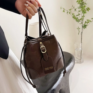 Fashionable dark brown contrast bucket bag for women with drawstring and gold buckle detail