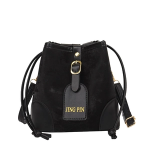 Elegant black velvet drawstring bucket bag with leather trim and gold buckle details