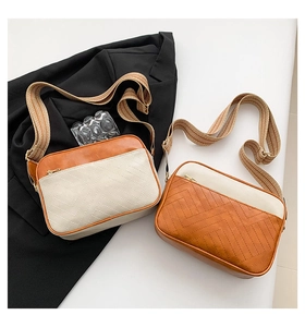 Close-up of color-block crossbody bags with V-shaped quilting and jacquard strap