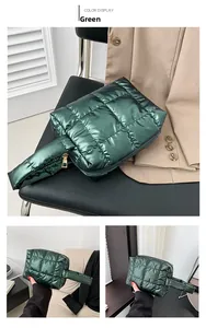 Detail view of a green quilted puffer tote bag featuring metallic nylon and gold zipper