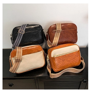 Detail view of four crossbody bags with V-quilted faux leather and geometric wide straps