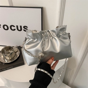 Silver metallic pleated cloud bucket bag with chain strap and metal ball ornament