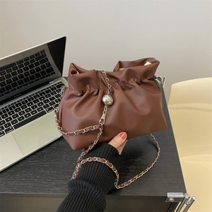 Caramel brown pleated bucket bag with silver metal chain and ball detail for women