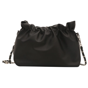 Minimalist black pleated bucket bag with metal chain strap on a white background