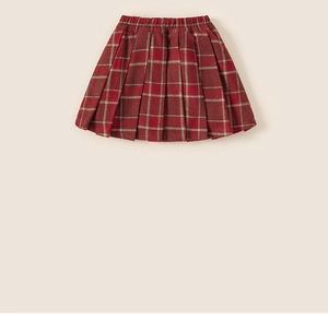 Close-up of red plaid pleated skirt for girls featuring thick wool-like fabric texture