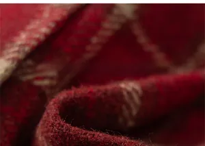 Close-up of thick red and beige plaid wool fabric with soft brushed texture