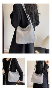 Detailed texture of light grey corduroy Hobo bag with large front pocket and wide strap