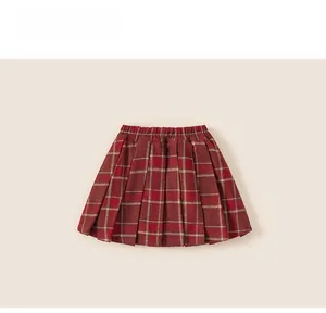 Detailed view of red plaid pleated skirt for girls with elastic waist and tartan pattern