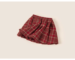 Close-up detail of British style red plaid pleated skirt for girls in thick wool fabric