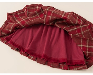 Detail of red plaid wool skirt showing thick textured fabric and smooth inner lining