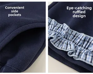 Close-up of side pockets and blue-white gingham ruffle trim on navy knit cotton trousers