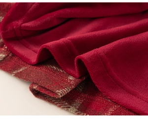 Detailed macro view of girls plaid skirt featuring warm red fleece lining and thick wool fabric