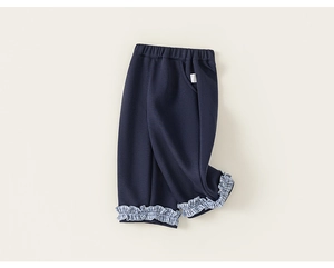 Macro shot of navy blue kids pants featuring ruffled blue and white checkered cuffs
