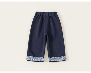 Close-up of kids navy knit trousers with stylish blue gingham ruffle hems and elastic waist