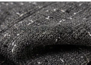 Detail of dark grey tweed fabric with white flecks showing thick woven texture and softness