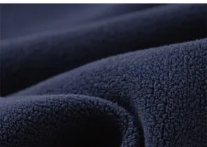 Macro shot of high-quality dark blue fleece fabric showing soft and warm texture details