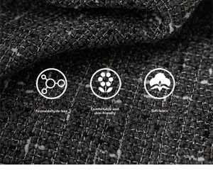 Detail of dark grey tweed fabric showing soft texture and high quality weaving details