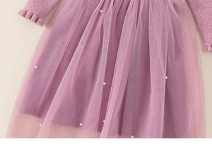 Detail of girl's lavender knit dress featuring sheer tulle skirt and pearl embellishments
