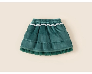 Détail d'une jupe à volants en velours vert foncé pour fille avec bordure en tulle