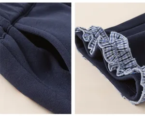 Detail of girls cotton casual trousers showing side pockets and plaid lace hem cuffs