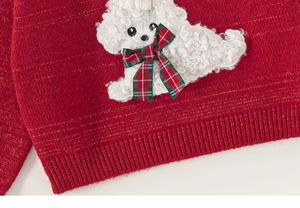 Detailed view of red knitted sweater with white puppy patch and red green plaid bow