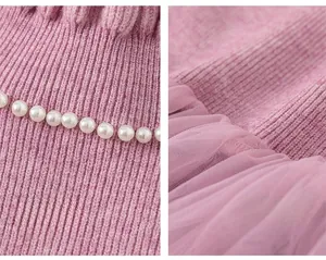 Detail of pink knitted girl dress with pearl collar and layered soft tulle mesh skirt