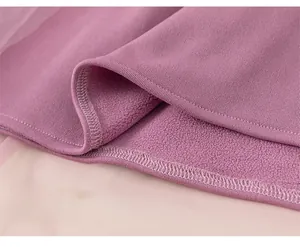 Detail of purple ribbed knit fabric with warm fleece lining and professional stitching