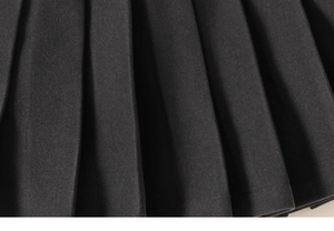 Detailed macro view of high-quality pleated fabric texture on girls winter skirt