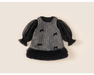 Close-up of girls' grey tweed dress featuring black bows and sparkly mesh sleeves