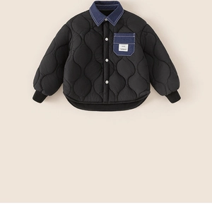 Detail of kids black quilted jacket featuring blue denim collar and contrast pocket