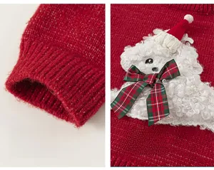 Detail of red knit sweater featuring a plush cartoon patch and a plaid bow decoration